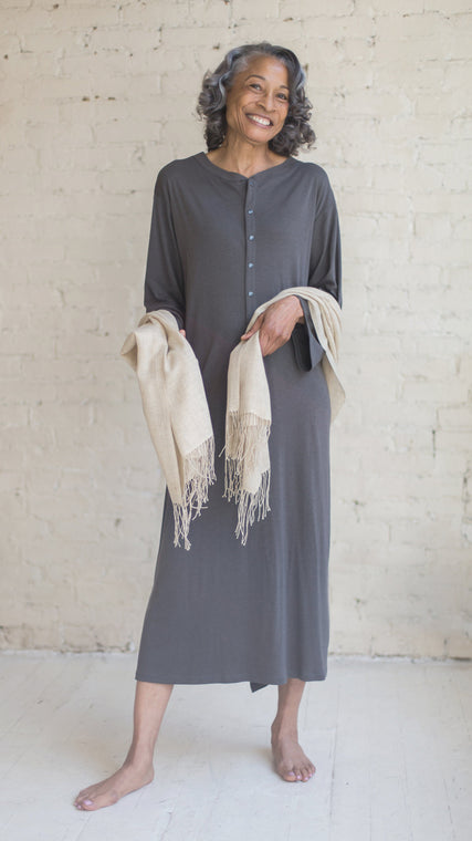 Load image into Gallery viewer, Woman wearing patient dressing gowns want to be stylish and fun as they believe health and healing are possible especially with cancer. Our slate grey hospital patient gown provides individuality, it's the best gift for patients with cancer and wanting modesty and warmth. Designer hospital gowns that are beautiful hospital gowns, in our opinion, can be synonymous with health and quality of life. An ode to dignity.