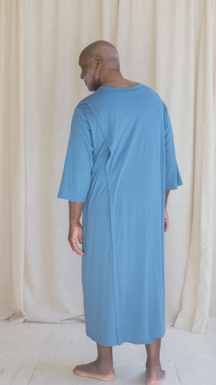 Load image into Gallery viewer, Man wearing mens hospital gown cotton ocean blue Henley, patient standing back view
