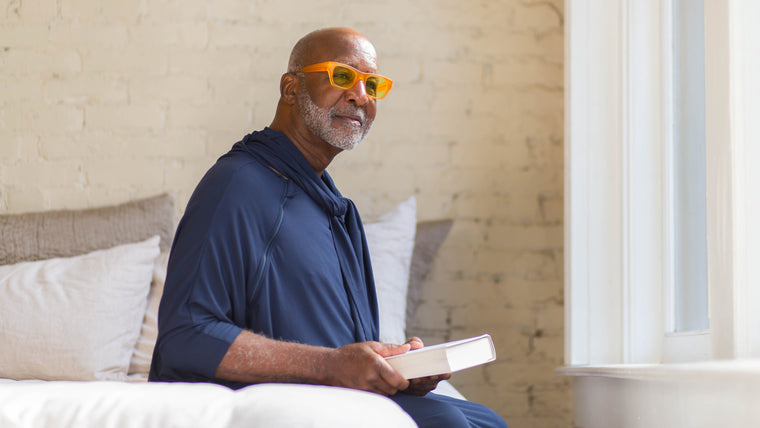 Load image into Gallery viewer, Wearing an Arkeras hospital gown in midnight blue with zipper front access and a lovely ascot adds dignity to the days of immobility and nurtures modesty for those needing more than a book, but that of community, friends and family, to help in the path to recovery and care.