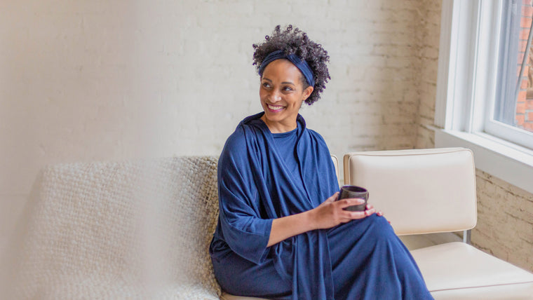 Load image into Gallery viewer, Our gorgeous African American model brought life to our Arkeras patient gown with her smile, depicting healthcare recovery at its best. Women with as beautiful a soul as she brings new life to the patient experience and recovery journey. The Classic Arkeras hospital gown has been designed by women and is a women-owned business, making decisions good for the planet and our communities future in healthcare.