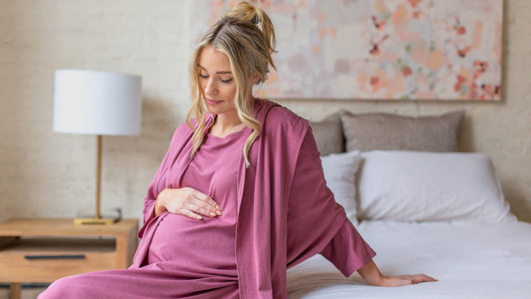 Load image into Gallery viewer, Postpartum care is your priority, but style is always on your mind and Arkeras gowns give size and color options for all moments of the patient birthing experience from maternity to labor and delivery to postpartum care. Check out the soft Classic hospital gown in peony shown on our beautiful blond model.