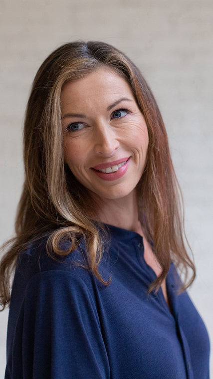 Load image into Gallery viewer, Woman wearing hospital patient gown Henley style in navy blue cotton closeup of face