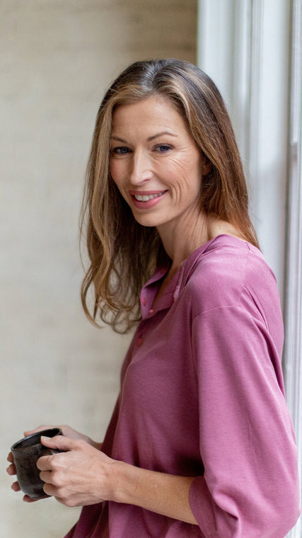 Load image into Gallery viewer, Woman wearing hospital patient gown lilac Henley holding a cup