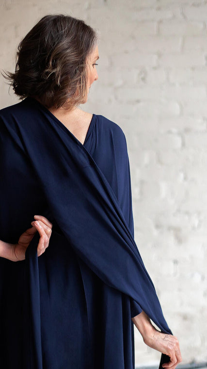 Load image into Gallery viewer, This modal blue patient gown has a distinct allure in this photo because no matter the stage-maternity, postpartum, annual exams, medi spa, cancer, post surgery, hospice-and health journey, we all want to feel desirable and needed. Arkeras is where you can buy a hospital gown for women and men for beauty, dignity, and longevity.