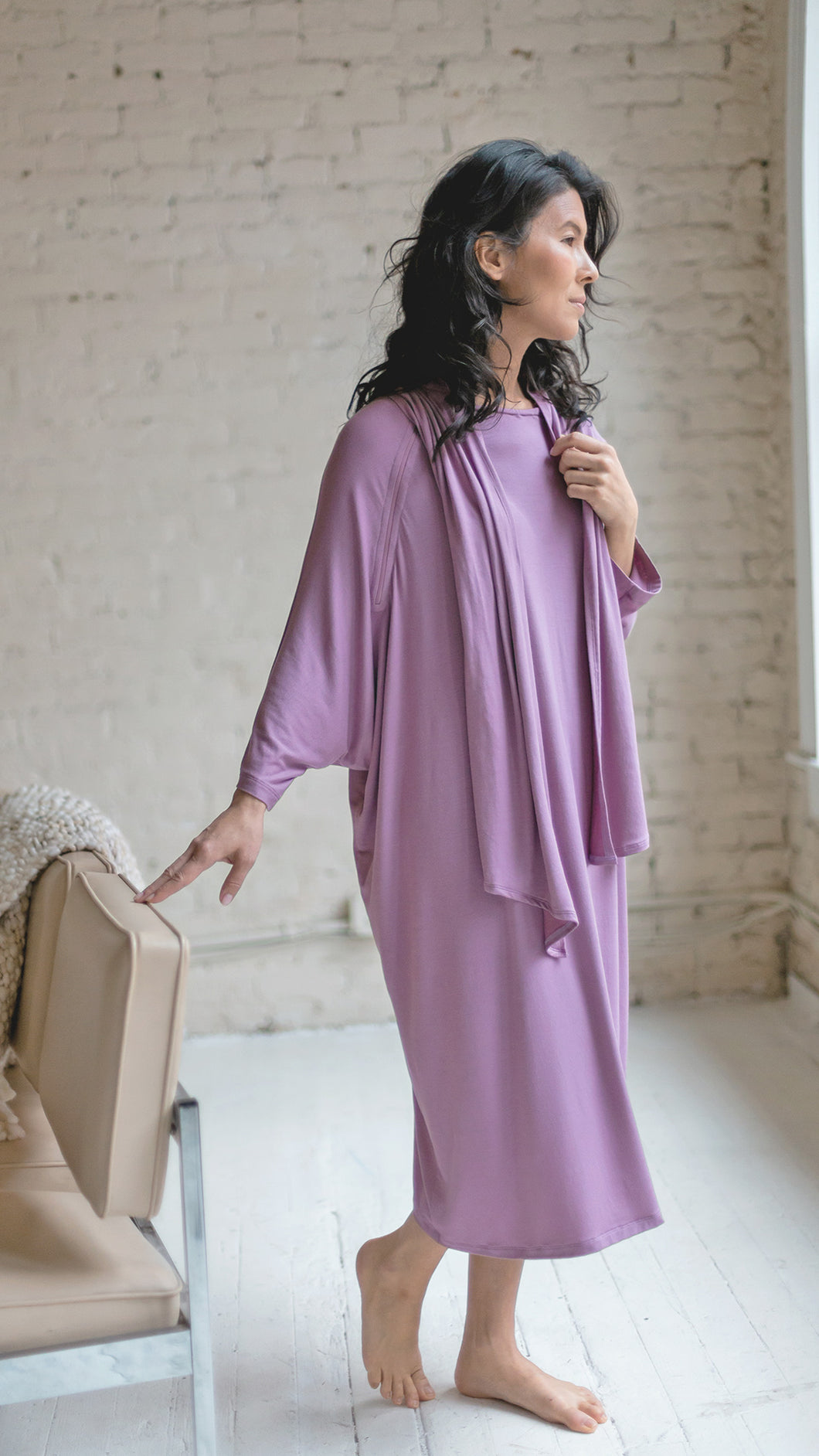 Woman wearing patient hospital gown in lilac modal fabric standing